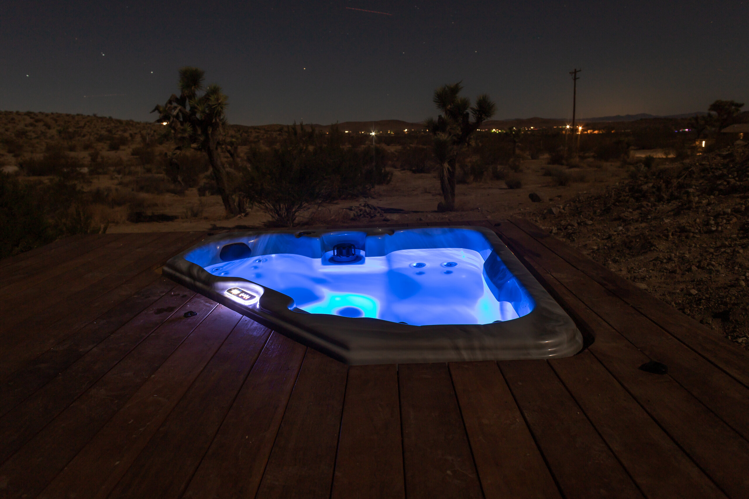 Hot tub glowing at night at Pause House PM