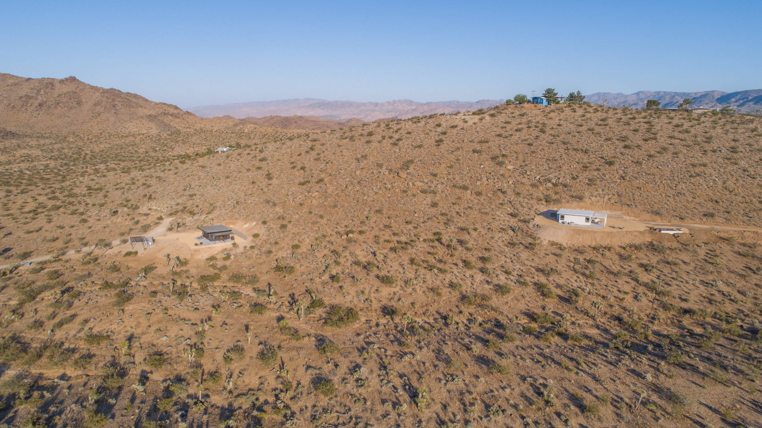 Aerial view of both Pause House cabins on adjoining ridges